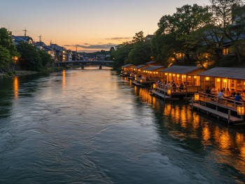 Traditional kawadoko platforms extending over the Kamo River with diners enjoying evening meals above flowing water. Traditional kawadoko platforms extending over the Kamo River with diners enjoying evening meals above flowing water.