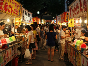 Colorful street food stalls at evening market with kakigōri shaved ice and traditional cooling treats. Colorful street food stalls at evening market with kakigōri shaved ice and traditional cooling treats.