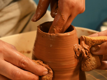 Artisan working on traditional pottery with focused concentration Photo by Taya Kucherova on Unsplash