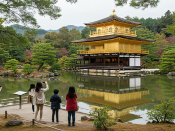 Kinkaku-ji from traditional viewing platform with tourists observing.