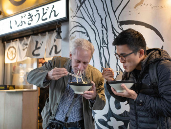 Tourists enjoying delicious food. Tourists enjoying delicious food.