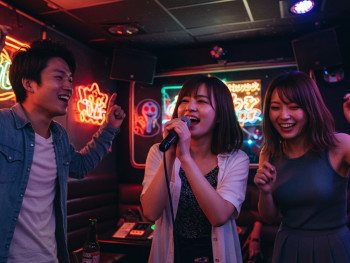 Friends enjoying karaoke in private room with colorful lighting. ImageFX Friends enjoying karaoke in private room with colorful lighting. ImageFX