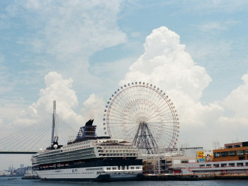Cruise ship docked at Osaka port with city skyline in background. Photo by Dong In Ham on Unsplash Cruise ship docked at Osaka port with city skyline in background. Photo by Dong In Ham on Unsplash