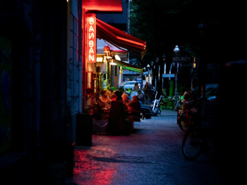 A narrow alley in Ura Namba with small bars and restaurants, their warm light spilling onto the street where a few locals chat outside. Photo by Rapha Wilde on Unsplash A narrow alley in Ura Namba with small bars and restaurants, their warm light spilling onto the street where a few locals chat outside. Photo by Rapha Wilde on Unsplash