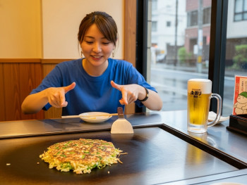 Mia cooking negiyaki at a self-cook grill Mia cooking negiyaki at a self-cook grill