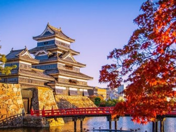 Matsumoto Castle with maple leaves in autumn Matsumoto Castle with maple leaves in autumn