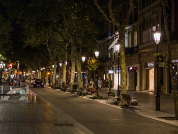 Well-lit evening street in Eixample Well-lit evening street in Eixample