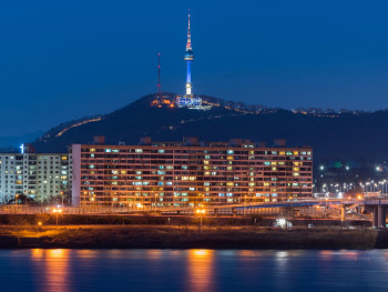 Scenic night view from Inwangsan mountain showing Seoul's fortress wall and city lights below Scenic night view from Inwangsan mountain showing Seoul's fortress wall and city lights below