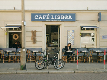 Lisbon café with people drinking espresso in the morning light