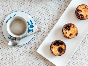 Close-up of coffee and pastéis de nata on a plate