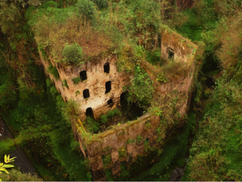 Sunset view of ivy-covered mill ruins in a green valley, Sorrento Sunset view of ivy-covered mill ruins in a green valley, Sorrento
