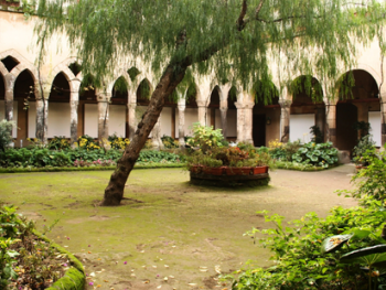 Tranquil medieval cloister with interlaced arches and garden Tranquil medieval cloister with interlaced arches and garden