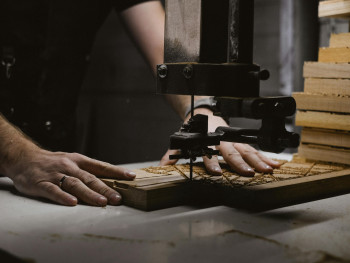 Artisan woodworker demonstrating inlaid wood technique Artisan woodworker demonstrating inlaid wood technique