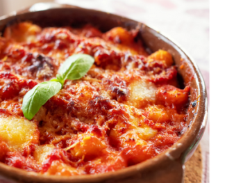 Baked gnocchi alla Sorrentina with melted cheese and basil