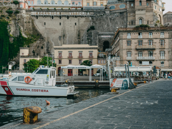 (P) Small fishing boats and pebble beaches in a quiet Sorrento harbor (P) Small fishing boats and pebble beaches in a quiet Sorrento harbor