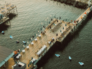 (P) Small harbor with fishing boats and waterfront cafes in the sun (P) Small harbor with fishing boats and waterfront cafes in the sun