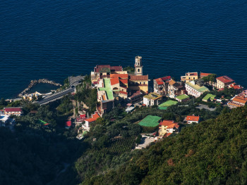 (P) Evening lights over a quiet coastal village with calm streets (P) Evening lights over a quiet coastal village with calm streets