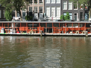 Cat boat exterior on calm canal Cat boat exterior on calm canal