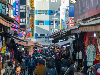 Bustling Namdaemun Market with rows of clothes