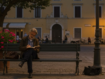 Traveler journaling in a quiet Sorrento piazza at dusk Traveler journaling in a quiet Sorrento piazza at dusk