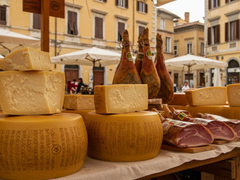 Parma market stalls with Parmigiano wheels and prosciutto in the old town Parma market stalls with Parmigiano wheels and prosciutto in the old town