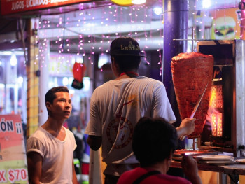 Row of suadero taco stands in Narvarte with Tacos al Pastor preparation