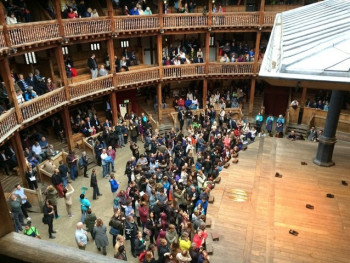 Groundlings gathered around the stage at Shakespeare’s Globe Theatre. Image by John H Darch via Wikicommons