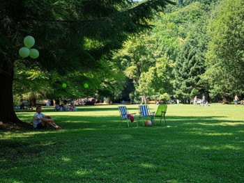 Parco Sempione with trees and people relaxing on the grass Parco Sempione with trees and people relaxing on the grass