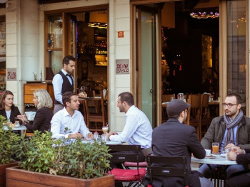 Outdoor café tables in Brera filled with locals enjoying coffee and conversation Outdoor café tables in Brera filled with locals enjoying coffee and conversation
