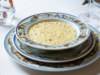 Traditional Milanese risotto served in a rustic Italian trattoria Traditional Milanese risotto served in a rustic Italian trattoria