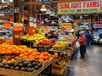 Bustling indoor food stalls at Granville Island market Bustling indoor food stalls at Granville Island market