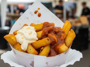 Freshly fried Dutch fries served in a paper cone with mayo and satay sauce Freshly fried Dutch fries served in a paper cone with mayo and satay sauce
