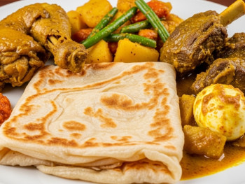 Plate of Surinamese roti with curry vegetables and tender meats Plate of Surinamese roti with curry vegetables and tender meats