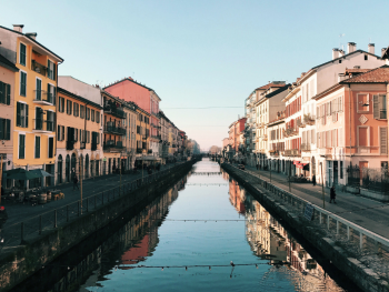 Still morning canal in Navigli with soft light on old buildings Still morning canal in Navigli with soft light on old buildings