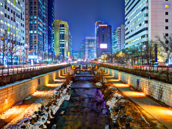 Illuminated Cheonggyecheon Stream with buildings reflected in the water Illuminated Cheonggyecheon Stream with buildings reflected in the water