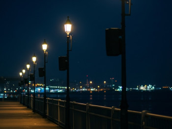 Barceloneta boardwalk at night with harbor lights