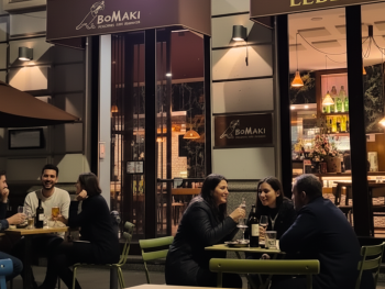 Cozy bar BoMaki in Porta Romana glowing under soft streetlights