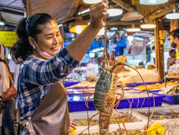 Early morning wet market with vendors arranging fresh produce Early morning wet market with vendors arranging fresh produce