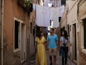 Alfama street at dawn, laundry hanging between buildings with quiet street Alfama street at dawn, laundry hanging between buildings with quiet street