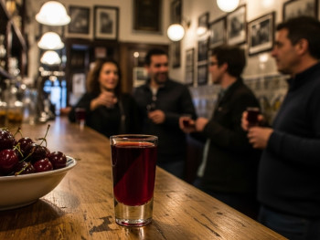 Dark red ginjinha shot at a small bar in Baixa, with locals enjoying the tradition Dark red ginjinha shot at a small bar in Baixa, with locals enjoying the tradition
