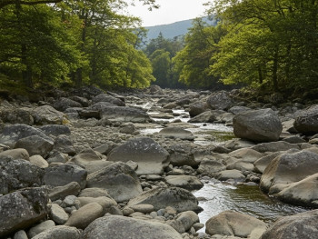Quiet river and granite rocks in Glenmalure Valley with scenic mountain views Quiet river and granite rocks in Glenmalure Valley with scenic mountain views
