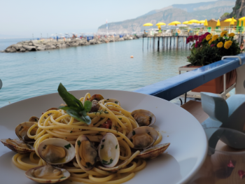 Spaghetti alle vongole at Marina Grande and gnocchi on a garden terrace Spaghetti alle vongole at Marina Grande and gnocchi on a garden terrace