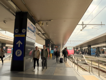 Termini platform board with morning commuters and trains Termini platform board with morning commuters and trains
