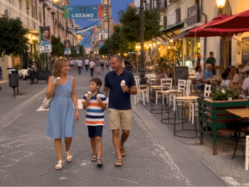 Families strolling Corso Italia with gelato after sunset Families strolling Corso Italia with gelato after sunset
