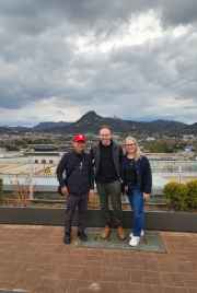 Tourists standing together under Seoul's dramatic, cloudy sky.
