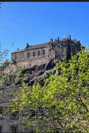 Edinburgh Castle stands majestically against a clear blue sky.