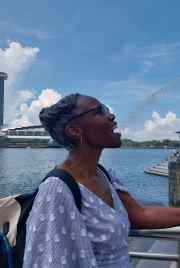 A playful moment with the Merlion's spray in Singapore.