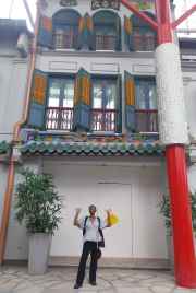 A curious glance up at Singapore’s colorful shophouse façade.