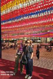 Joyful faces amidst Seoul's dazzling displays of tradition.