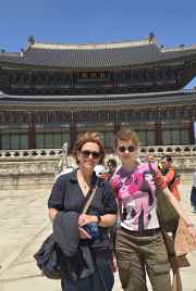 Traditional hanboks bring vibrant colors to the palace courtyard scene.